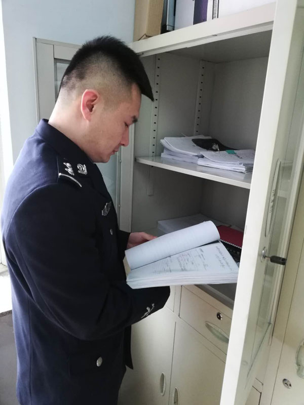 圖二，辛楊查閱卷宗，在一摞摞卷宗材料中尋找線索