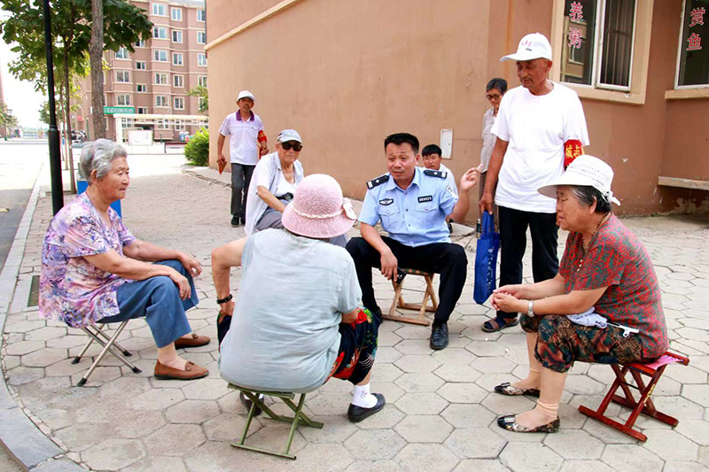 李化瑞和轄區(qū)群眾聊家常，聽取他們對小區(qū)平安建設的意見和建議。