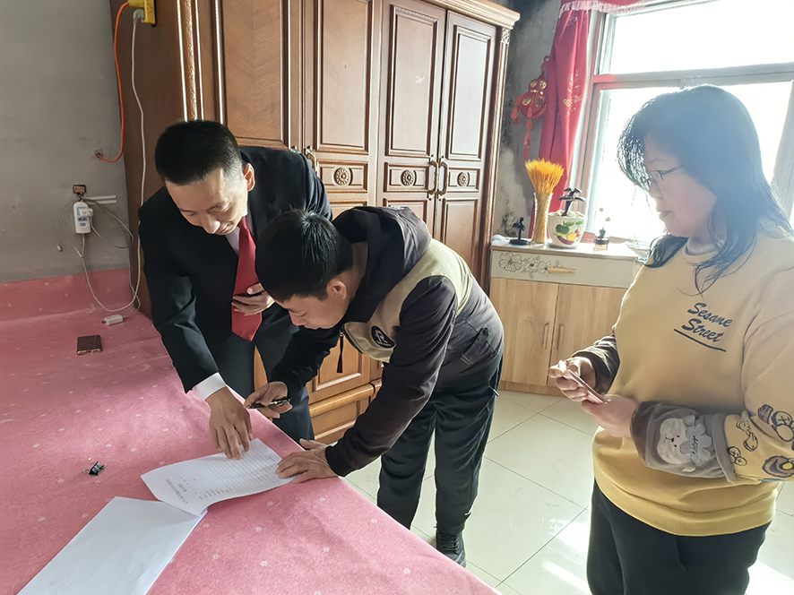 徐曉東（左一）指導孟某（中）在結案書上簽字